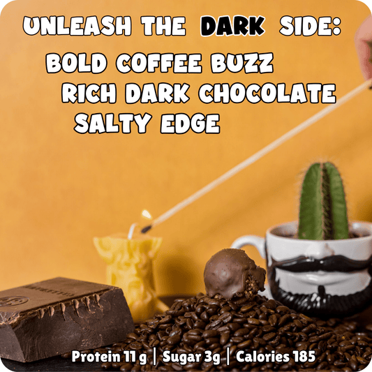 Coffee and dark‑chocolate protein ball with a hint of sea salt. Sitting on a hill of coffee beans next to a bearded mug and a candle being lit.