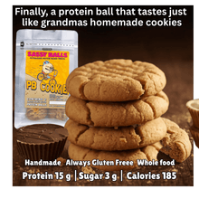 Load image into Gallery viewer, Stack of peanut butter cookies with a protein ball package labeled 'PB Cookie' on a dark background.