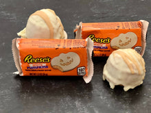 Load image into Gallery viewer, Peanut butter truffle protein balls sitting next to Reese's Peanut Butter Cups packages
