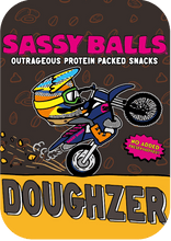 Load image into Gallery viewer, Product packaging for 'Sassy Balls' with a cartoon character on a motorcycle and text about protein-packed snacks.