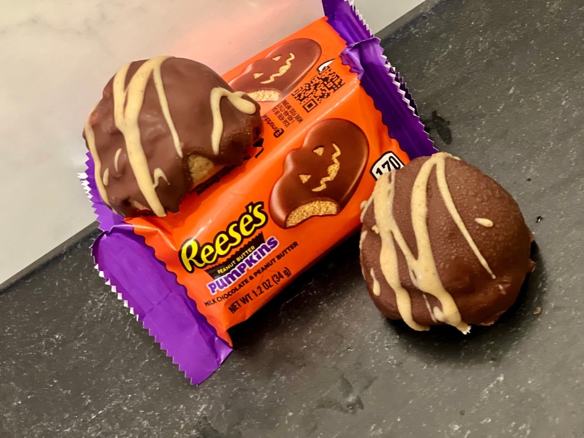 PB Bomb Peanut Butter Truffle Energy Bites looking dangerously addictive next to Reese's Pumpkin – one savage bite reveals that stupidly satisfying creamy peanut butter center